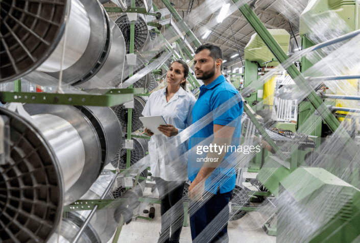 plastic engineers examining machine