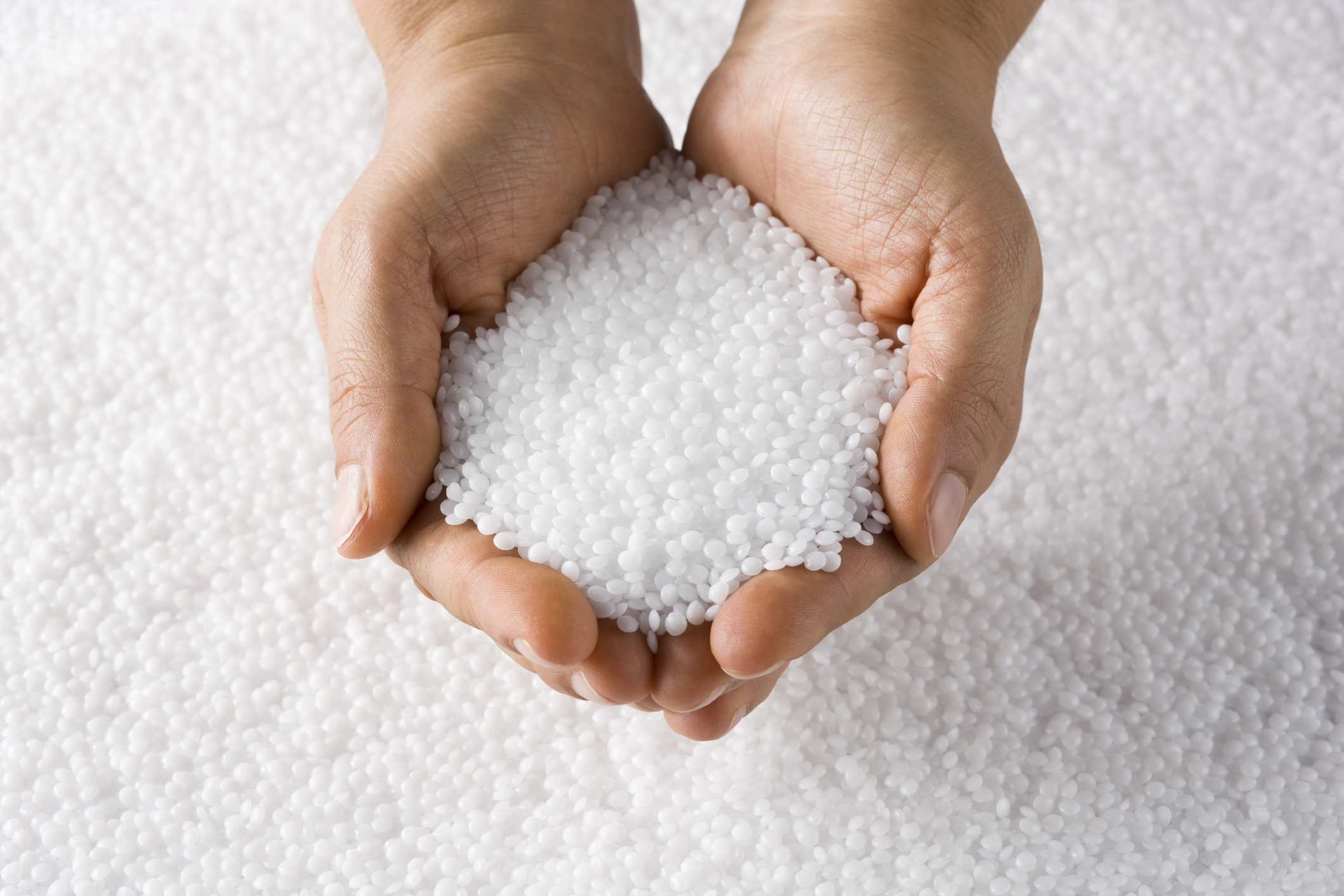 man holding plastic pellets