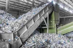 escalator with a pile of plastic bottles at the factory for processing and recycling