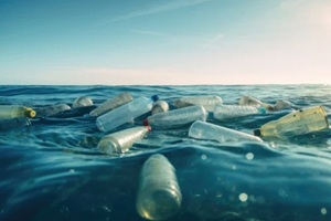 plastic bottles and trash floating in the ocean
