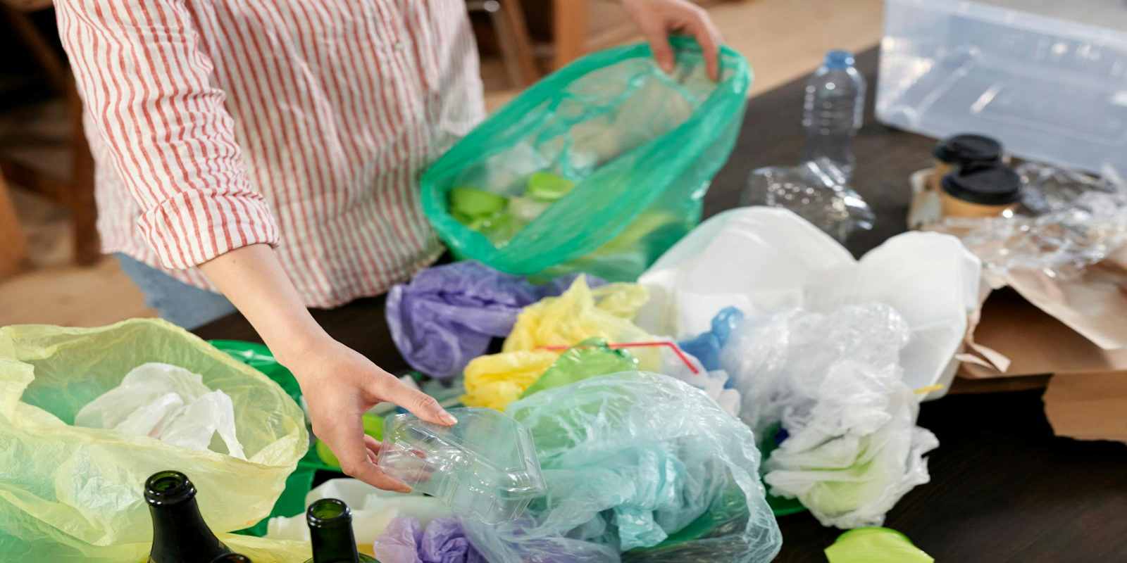 A Person Sorting Plastic Waste for Recycling