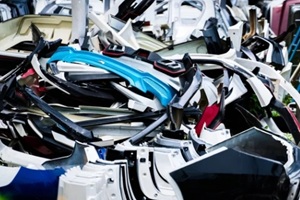 pile of used front bumper, rear bumper, and spoiler of car for recycle