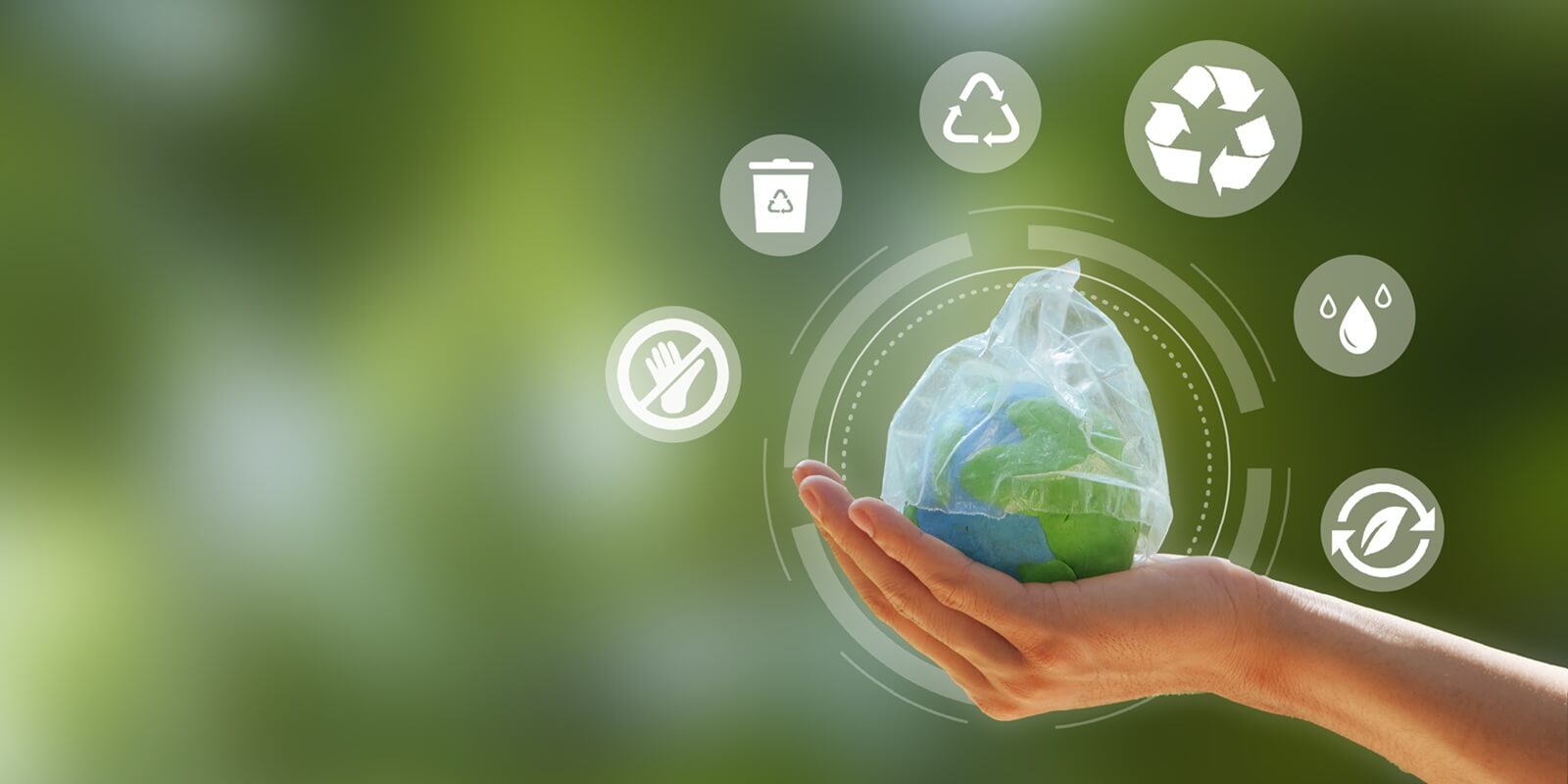 hand holding the earth that plastic bag covering on a green background