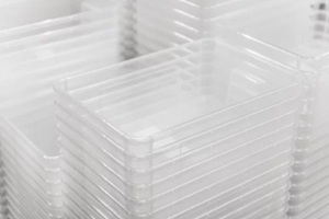 stack of transparent plastic trays