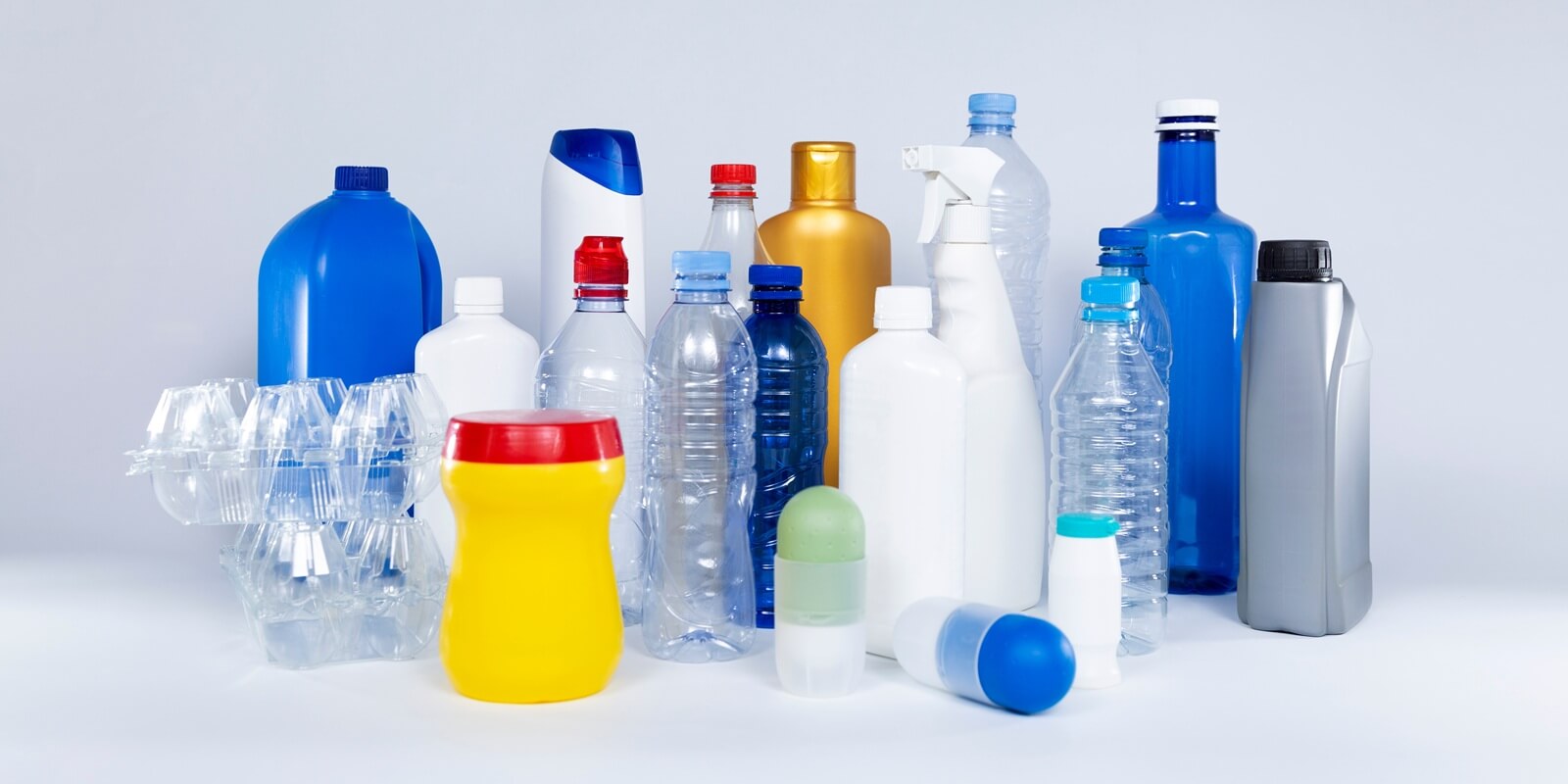 household plastic containers of different sizes and shapes isolated on white background. Recycling concept