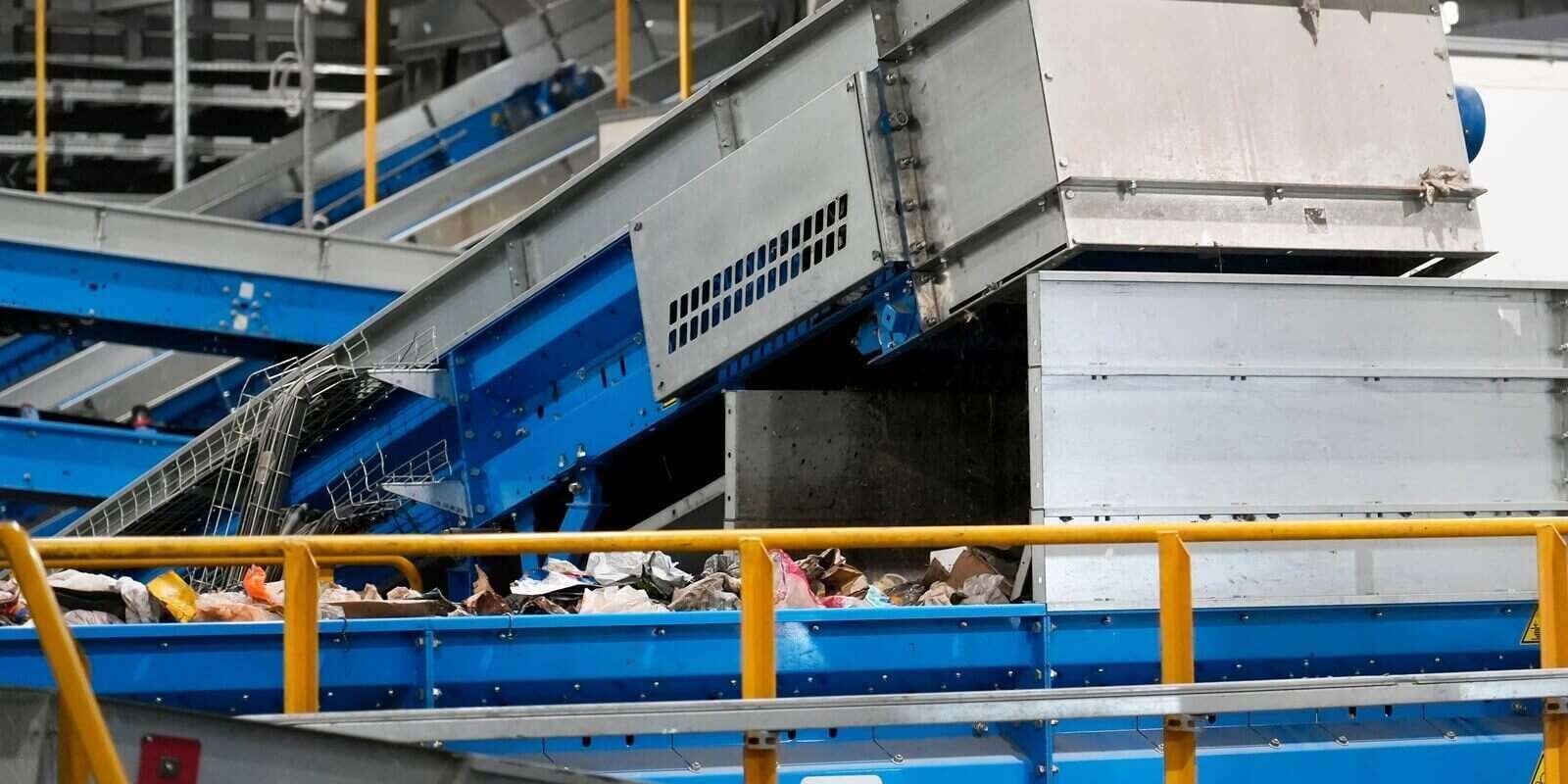 conveyor belts at a waste sorting facility are moving mixed materials for efficient recycling