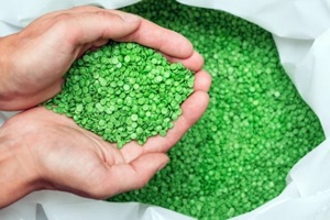 hands hold or touching biodegradable plastic pellets, plastic polymer granules