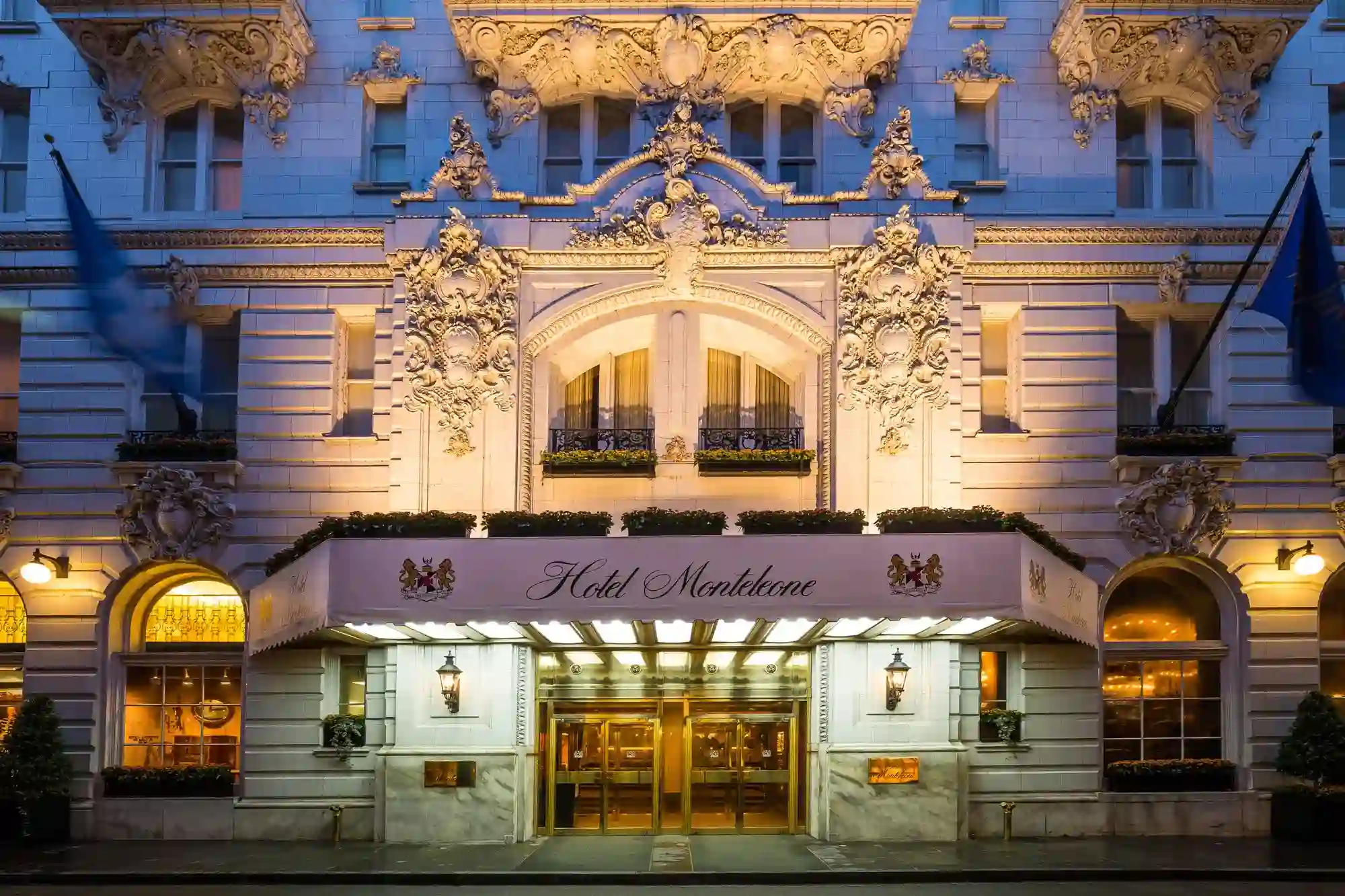 The grand, ornate facade of the historic Hotel Monteleone in New Orleans is brilliantly illuminated at twilight.